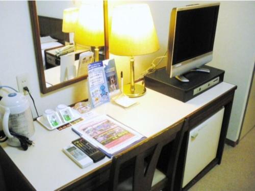 a desk with a computer and a monitor on it at Sky Heart Hotel Kawasaki - Vacation STAY 97869 in Kawasaki