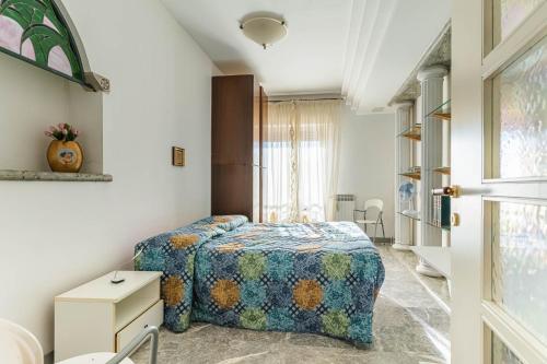 a bedroom with a bed and a table and a window at Anita Domus - Appartamento con vista a Pescara in Pescara