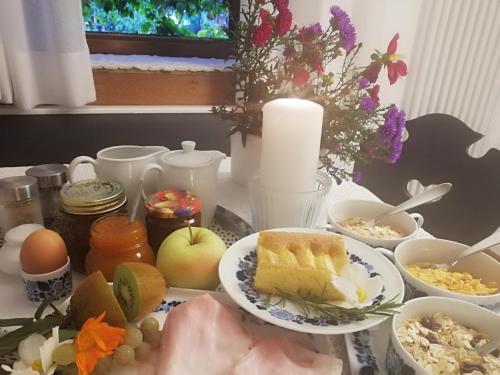 a table topped with plates of food and other foods at Ansitz Grustdorf in Appiano sulla Strada del Vino