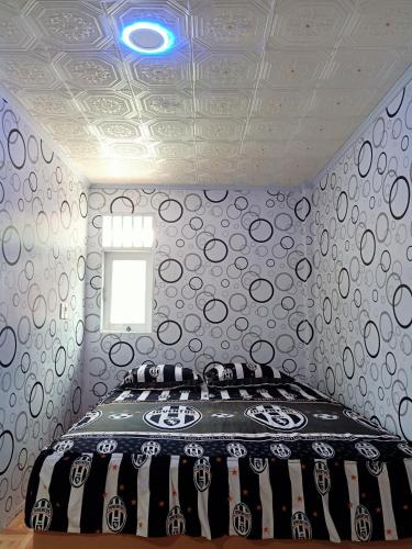 a bedroom with a bed in a room with a ceiling at Ustin Nagoya Bukit Lawang Orangutan Trekking & transport You can only stay at the hotel if you book your trekking with us in Bukit Lawang