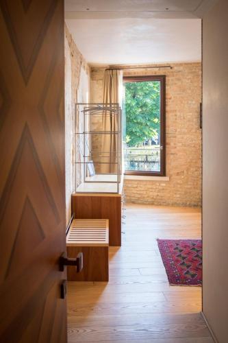 a room with a bed and a window at Locanda Ponte Dante in Treviso