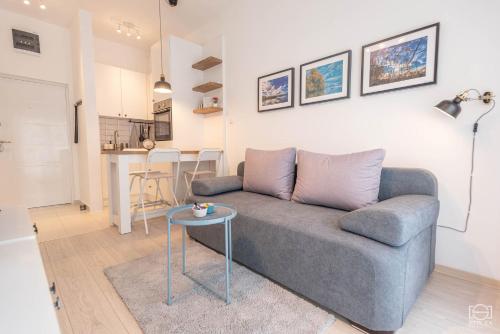a living room with a couch and a table at Apartman Bombonica in Banja Koviljača