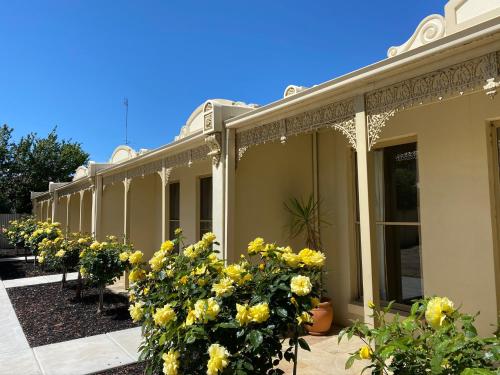 a building with a bunch of flowers in front of it at Acacia Terraces in Echuca