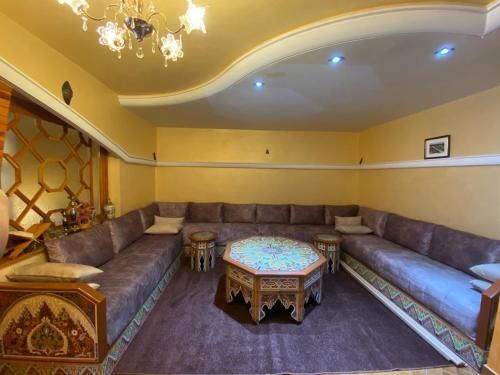 a living room with a couch and a table at Très joli appartement au centre de IFRANE in Ifrane