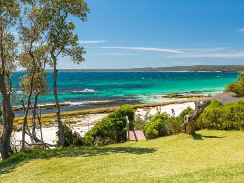 a beach with the ocean in the background at Bimbadgen at Hyams Beach in Hyams Beach
