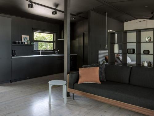 a living room with a couch and a table at Black Shack on Hyams Beach in Hyams Beach