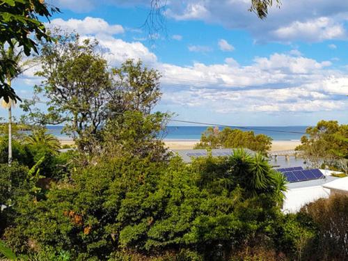 a view of a beach with trees and the ocean at Bombora Gerroa in Gerroa