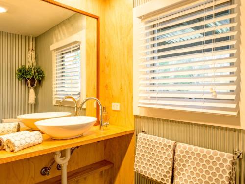 a bathroom with a sink and a mirror at Mirriyindi for 9 Berrima in Berrima