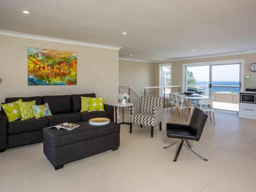 a living room with a couch and a table at Peninsula 180 Gerroa in Gerroa