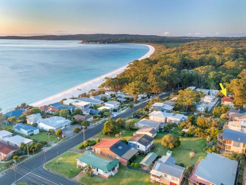 an aerial view of a beach with houses and the ocean at Sandals at the Bay Upstairs sleeps 6 Hyams Beach in Hyams Beach