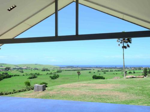 a view of a field from inside a house at Rose Valley Gerringong in Rose Valley