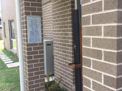 a brick wall with a sign on the side of a building at Sea Mist Gerringong in Gerringong