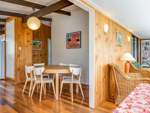 a dining room with a table and chairs at Shanti at Hyams Beach in Hyams Beach