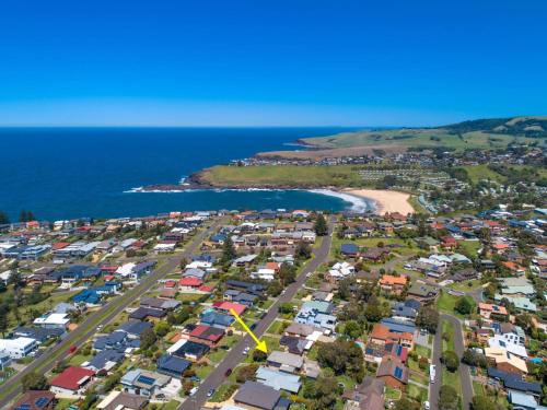 an aerial view of a suburb with houses and the ocean at Spindrift Kiama in Kiama