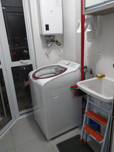 Baño pequeño con aseo y lavamanos en Apartamento Família Santos, en Penha