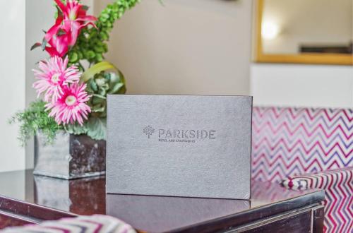 a box sitting on top of a table with flowers at Parkside Hotel & Apartments in Auckland
