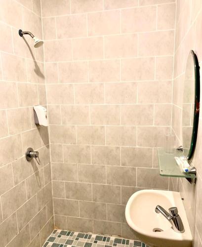 a bathroom with a sink and a shower at Sky View Hotel Managed by OS in Batam Center