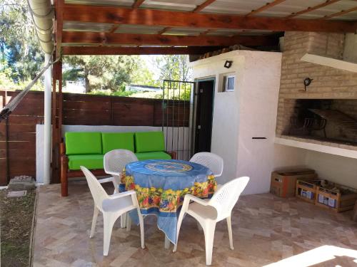 a patio with a table and chairs and a green bench at ELIMAR in Playa Verde