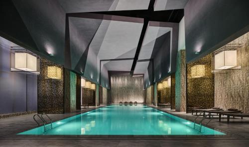 a swimming pool in a building with a ceiling at Crowne Plaza Qidong, an IHG Hotel in Qidong