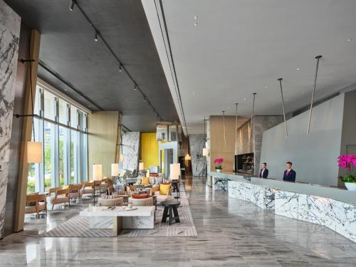 a lobby of a hotel with tables and chairs at Crowne Plaza Qidong, an IHG Hotel in Qidong