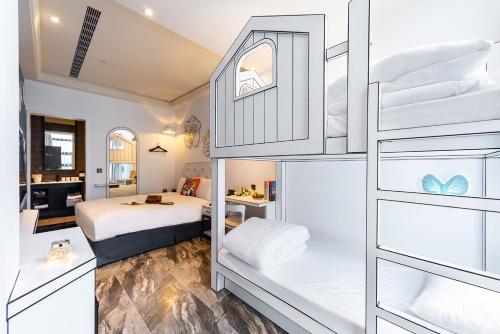 a bedroom with two bunk beds and a bathroom at Norway Forest Travel hotel 3 Taichung in Taichung