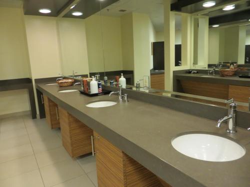 a bathroom with two sinks and a large mirror at Primm Valley Hotel & Casino, a Travelodge by Wyndham in Primm