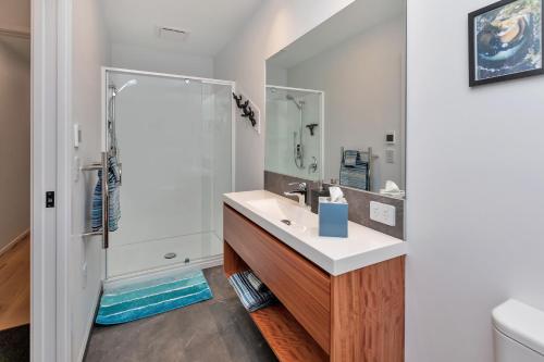 a bathroom with a sink and a shower at Roy and Anns Haven in One Tree Point