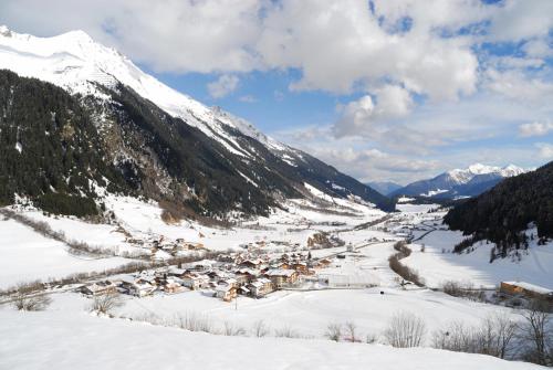 a small town in the snow with a mountain at Fassnauerhof Ridnaun in Racines