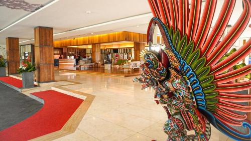 a peacock statue in a lobby of a mall at Truntum Kuta Bali in Kuta