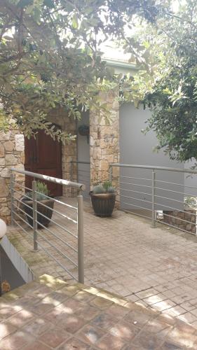 a patio with a fence in front of a building at The Haven in Jongensfontein