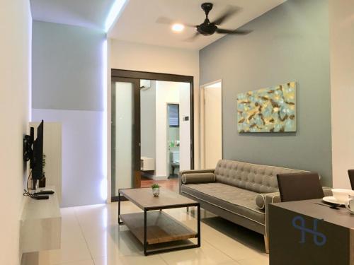 a living room with a couch and a table at Homesuite' Home at The Loft in Kota Kinabalu