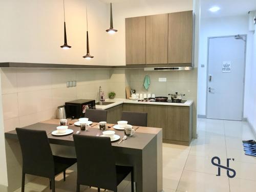 a kitchen and dining room with a table and chairs at Homesuite' Home at The Loft in Kota Kinabalu