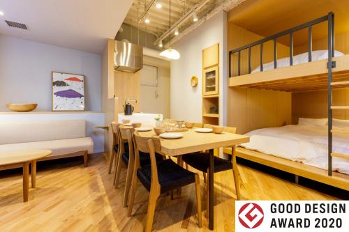 a room with a dining table and a bunk bed at tefu yoyogi uehara 101 - good design award - in Tokyo