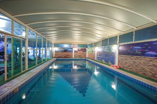 a swimming pool in a building with a ceiling at Meral Crown Hotel in Riyadh