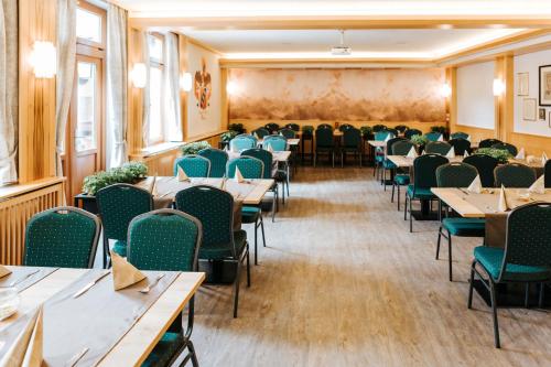 
a large room filled with tables and chairs at Gasthof Mang in Ybbs an der Donau
