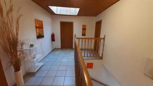 a staircase in a room with a skylight at Ferienwohnungen & Weingut Kroiss Silvia in Illmitz
