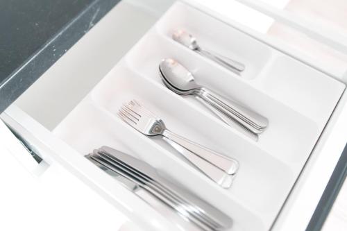a white drawer with silver utensils in it at Laurentroom Center in Ukmergė