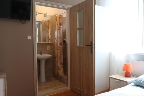 łazienka z umywalką, toaletą i drzwiami w obiekcie City Apartments & Gym we Wrocławiu