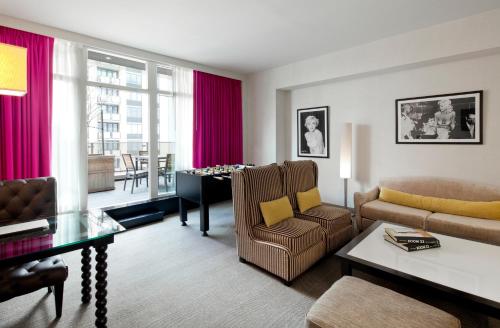a living room with a couch and a table at Royalton Park Avenue in New York