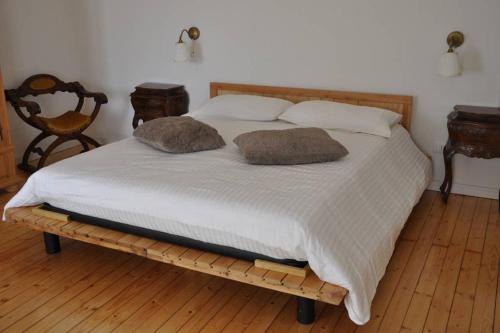 a bed with two pillows on it in a bedroom at Casale LUEL in Valeggio sul Mincio