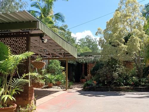 a house with a porch with plants and trees at Charming country house close to Grafton in Waterview Heights