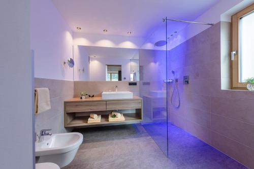 a bathroom with a sink and a shower at Alpwellhotel Burggräfler in Tesimo