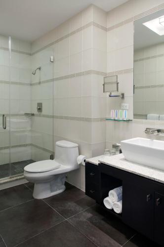 a bathroom with a toilet and a sink at Royalton Park Avenue in New York