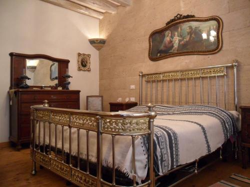 Lova arba lovos apgyvendinimo įstaigoje La Dimora di Gaspare