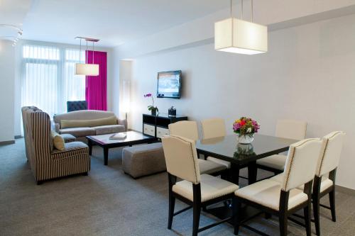 a living room with a dining room table and chairs at Royalton Park Avenue in New York