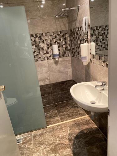 a bathroom with a sink and a shower at Cyprotel Faliraki in Faliraki