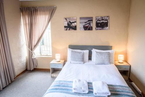 a bedroom with a bed with two towels on it at Drum Rock 5 in Clarens
