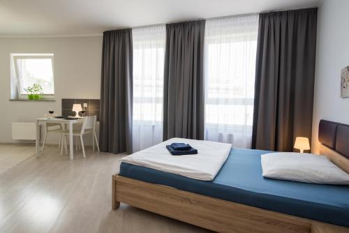 a bedroom with a bed and a desk in it at Parkowa 13 in Szczecin