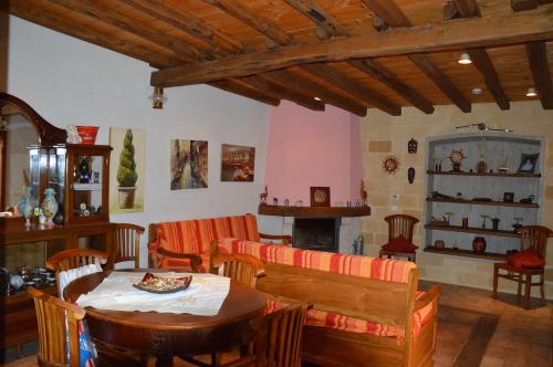 a dining room with a table and chairs and a fireplace at La Dimora di Gaspare in Locogrande