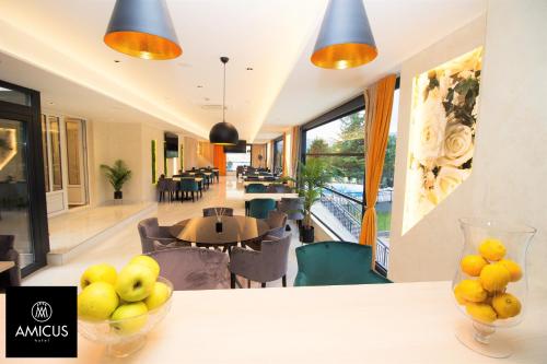 a room with a table with a bowl of fruit on it at Hotel Amicus in Mostar